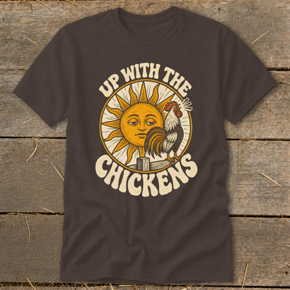 A dark brown t-shirt featuring a retro graphic of a crowing rooster, a smiling sun, and the text Up With The Chickens.