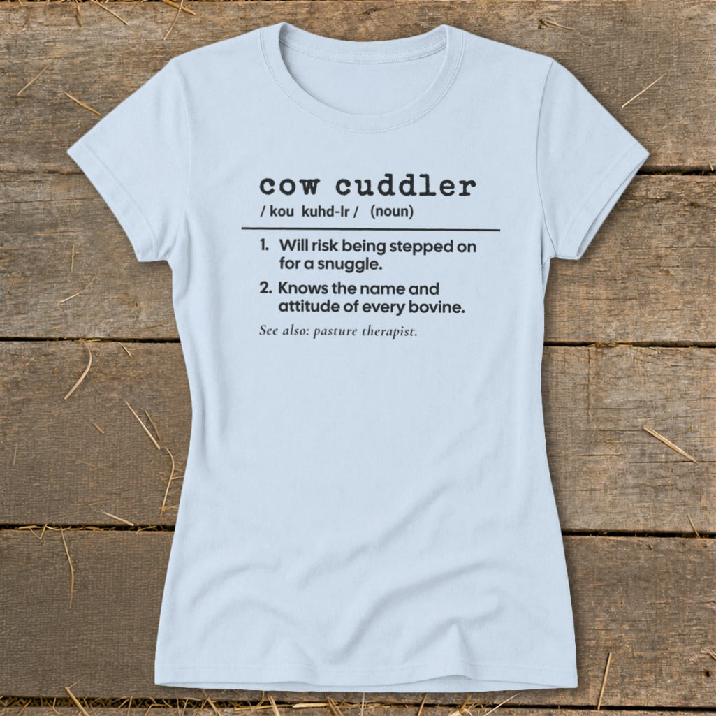 Light blue t-shirt with "cow cuddler" definition printed in black.