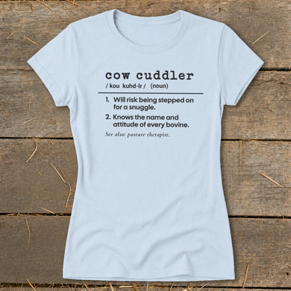 Light blue t-shirt with "cow cuddler" definition printed in black.