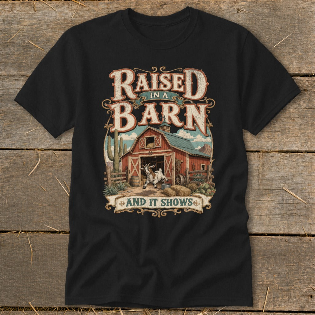 Black t-shirt with "Raised in a Barn and it Shows" text and barn graphic.
