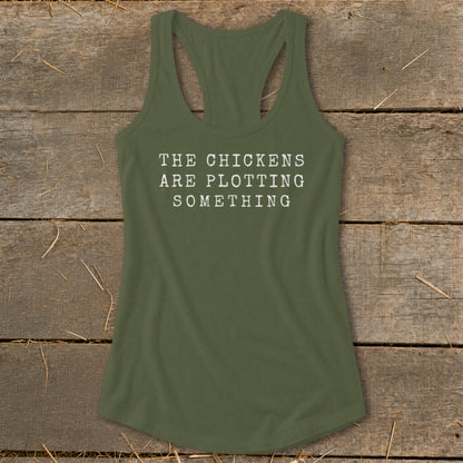 Green tank top with white text reading "THE CHICKENS ARE PLOTTING SOMETHING".