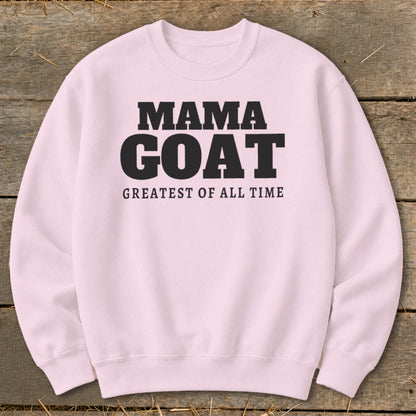 Pink crewneck sweatshirt with "MAMA GOAT GREATEST OF ALL TIME" text.