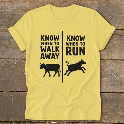 Yellow t-shirt with black text "Know When to Walk Away" and a cow, and "Know When to Run" and a running cow.