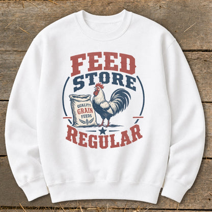 White sweatshirt with a "Feed Store Regular" graphic featuring a rooster and bag of grain.