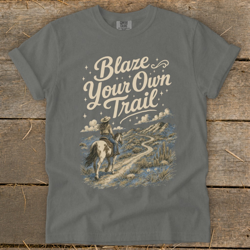 Grey t-shirt with "Blaze Your Own Trail" text and a desert landscape with a person on horseback.