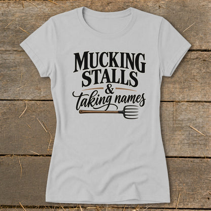 Grey t-shirt with "Mucking Stalls & Taking Names" text and a pitchfork graphic.
