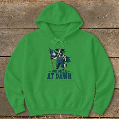 Green hoodie with graphic of cow holding flag that reads "We Milk At Dawn".