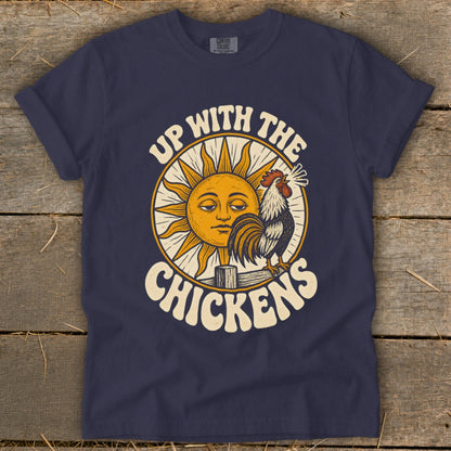 Dark blue t-shirt featuring a retro graphic of a rooster crowing next to a sleepy sun and the text "Up With The Chickens".