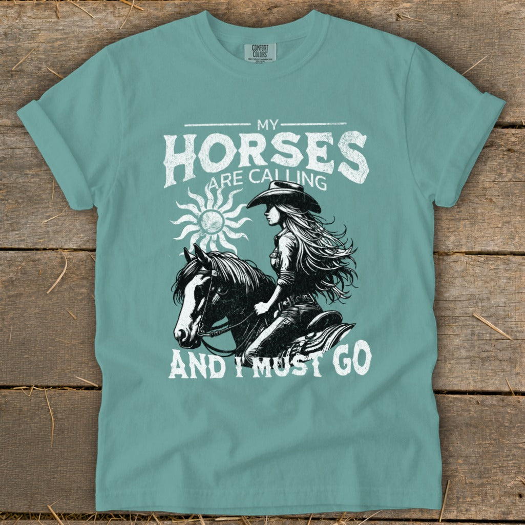 T-shirt with "My Horses Are Calling And I Must Go" text and horse rider graphic.