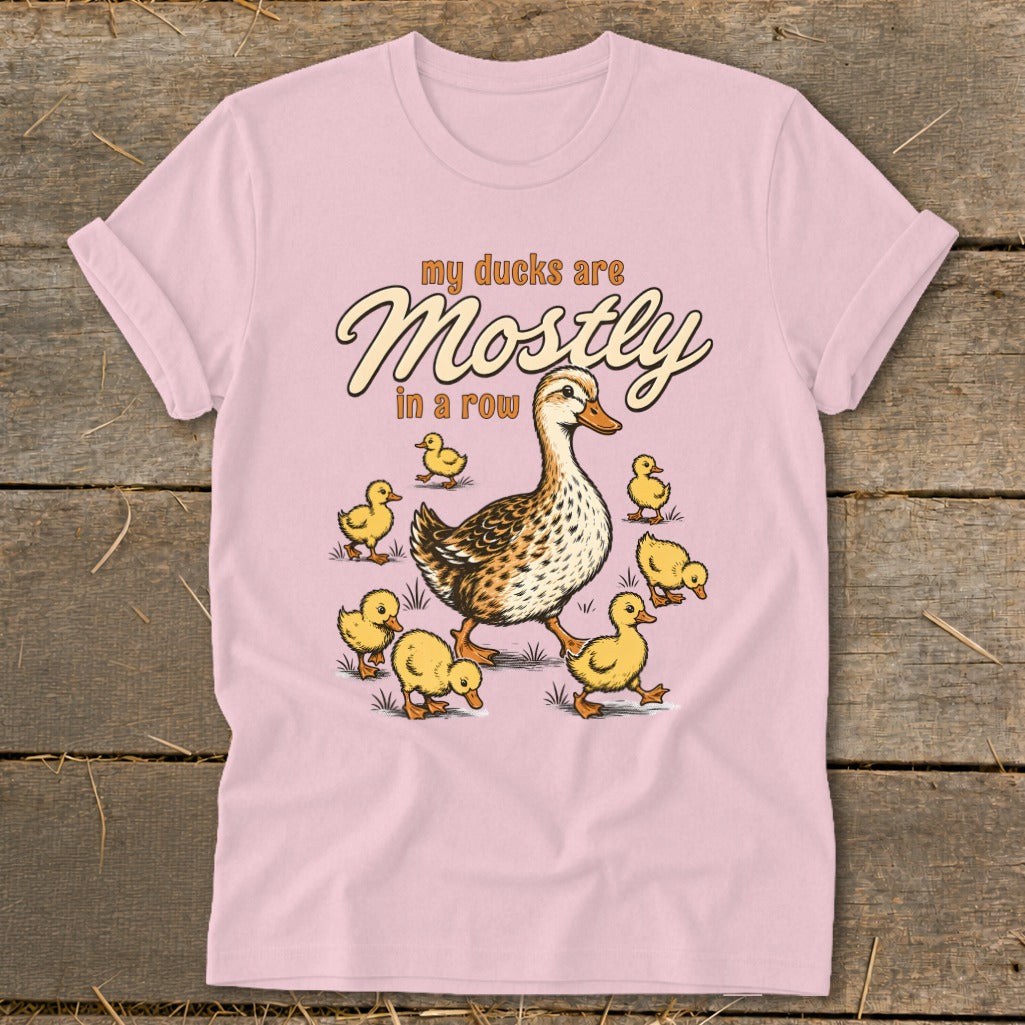 Pink t-shirt with a mother duck and seven ducklings, text "my ducks are Mostly in a row".