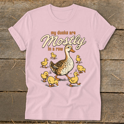 Pink t-shirt with a mother duck and seven ducklings, text "my ducks are Mostly in a row".