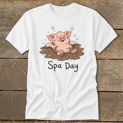 White t-shirt with cartoon pig in mud with "Spa Day" text.