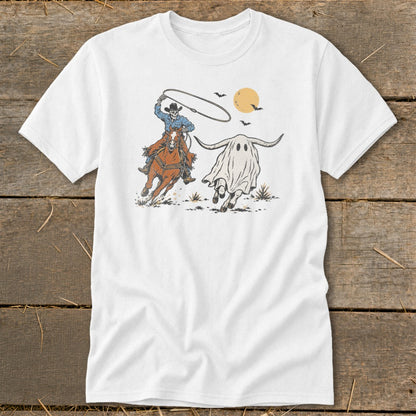 Skeleton cowboy on horse lassoing a ghost longhorn under a full moon.
