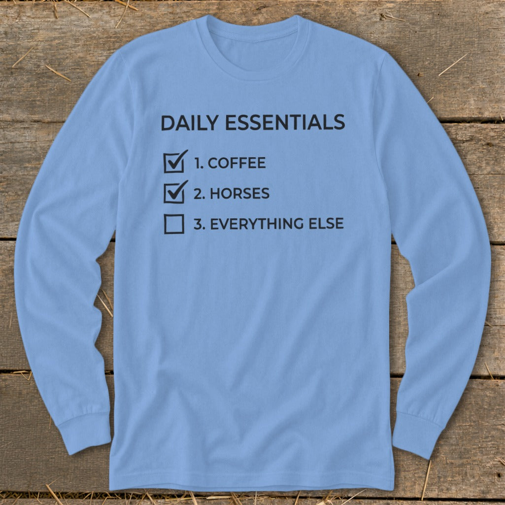Light blue long-sleeve shirt with text "Daily Essentials" and a checklist.