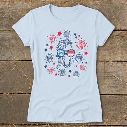 Light blue t-shirt with a horse wearing American flag sunglasses surrounded by fireworks.