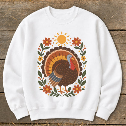 White sweatshirt with a cartoon turkey design featuring a sun and floral border.