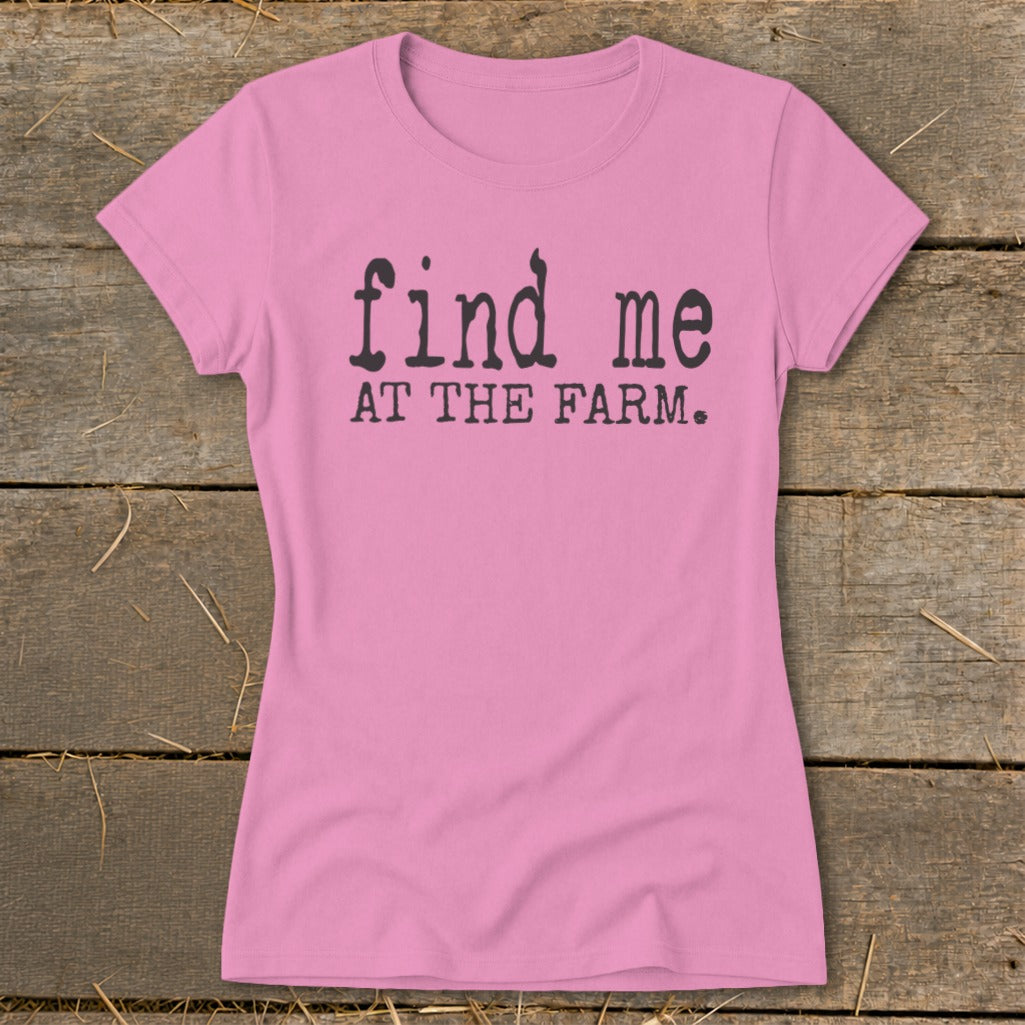 Pink t-shirt with black text that reads "find me AT THE FARM."