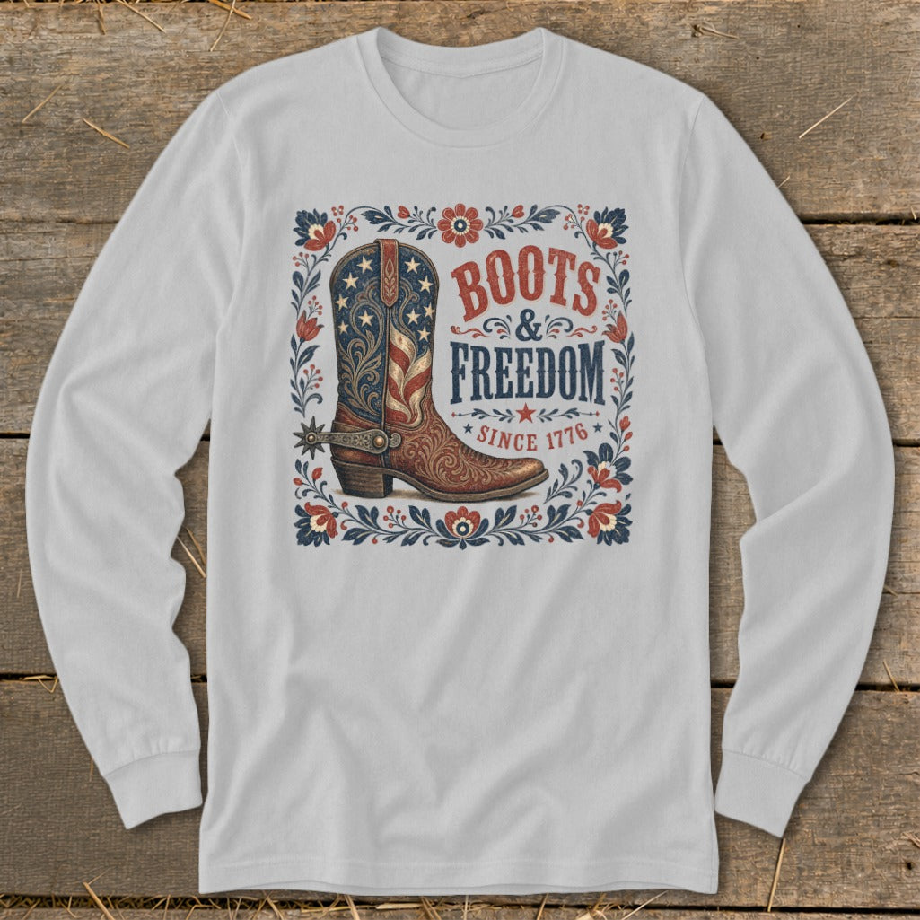 White long-sleeve shirt with a distressed graphic of a cowboy boot and "Boots & Freedom Since 1776".