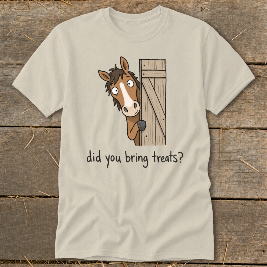Light tan t-shirt with a cartoon horse peeking around a wooden gate asking "did you bring treats?".