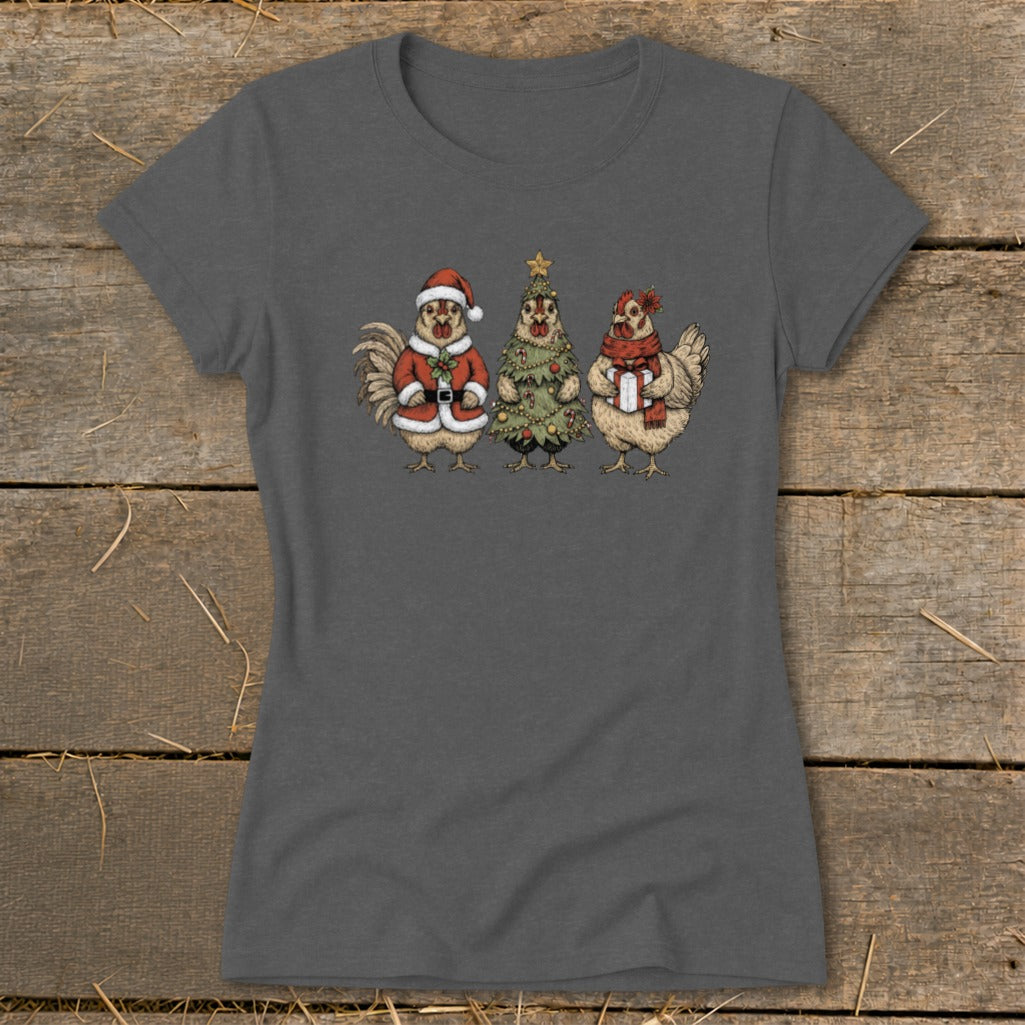 Three chickens dressed for Christmas: one as Santa, one as a tree, one with a gift.