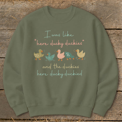 Green sweatshirt with text "I was like 'here ducky duckies' and the duckies here ducky duckied" and five ducks.