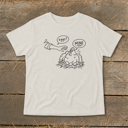 Line drawing on shirt of chicken on nest with eggs and a hand reaching out with text "eggs?" and "MINE".