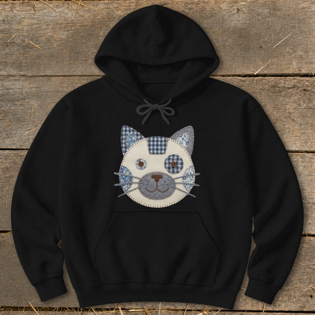 Black hoodie with a patchwork cat face applique.