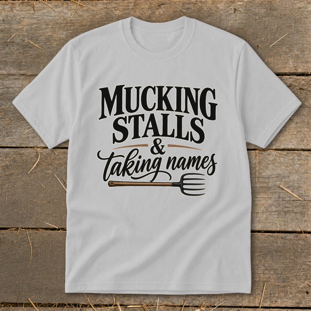 White t-shirt with "Mucking Stalls & Taking Names" and a pitchfork graphic.