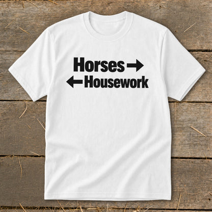 A white crewneck t-shirt with black text reading Horses with a right arrow and Housework with a left arrow.