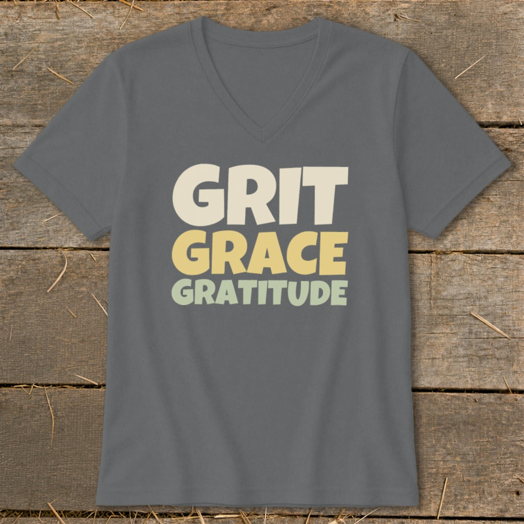 Dark gray V-neck T-shirt with the text Grit Grace Gratitude printed on the chest in cream, yellow, and light green.