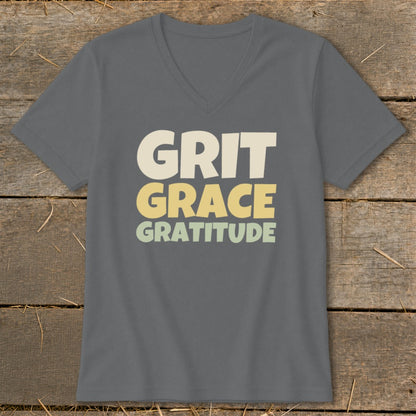 Dark gray V-neck T-shirt with the text Grit Grace Gratitude printed on the chest in cream, yellow, and light green.