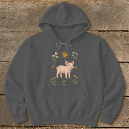 Dark gray hoodie with a pink pig illustration surrounded by flowers and a sun.