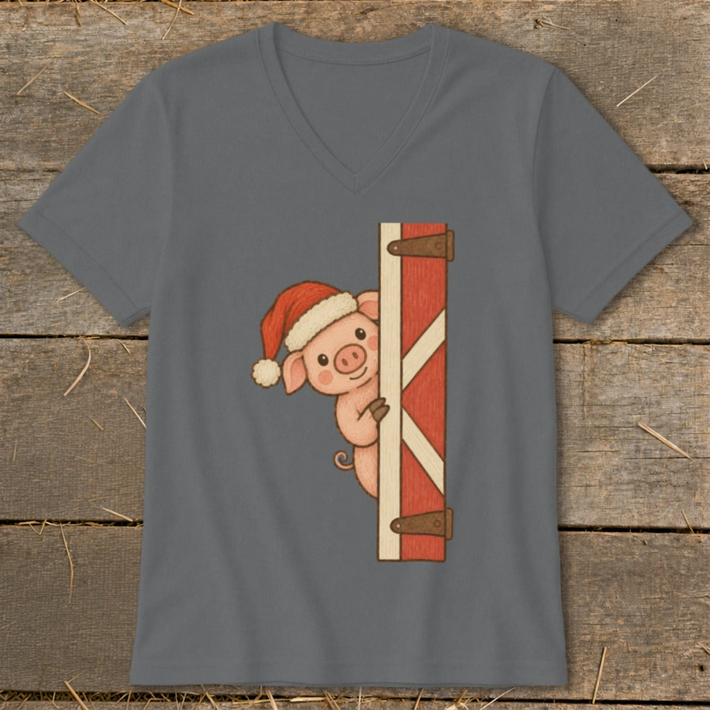Cute pig wearing a Santa hat peeking from behind a barn door.
