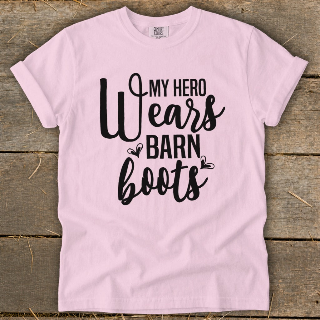 Pink t-shirt with "MY HERO Wears BARN boots" graphic.