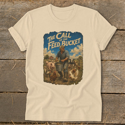 T-shirt graphic with text "The Call of the Feed Bucket" and a farmer feeding farm animals.