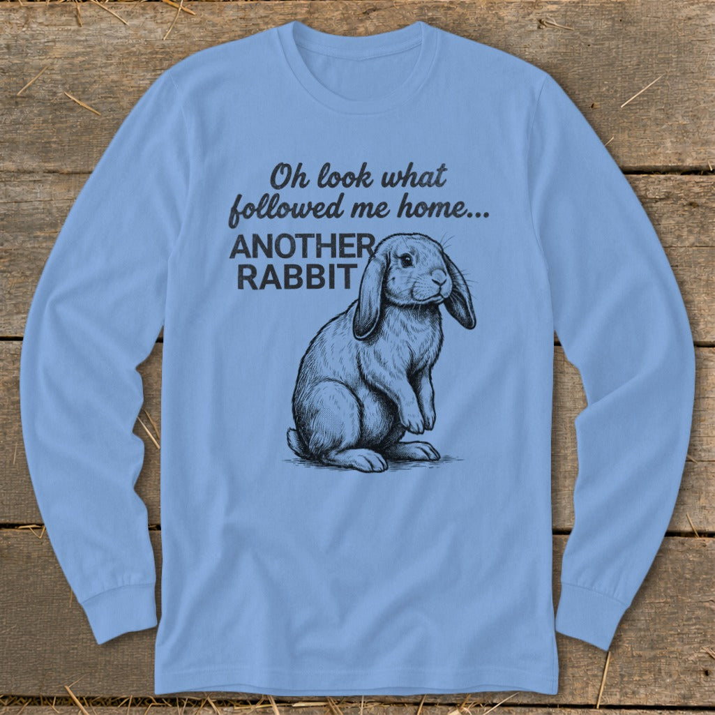 Light blue long-sleeve shirt with sketch of rabbit and text "Oh look what followed me home... ANOTHER RABBIT".