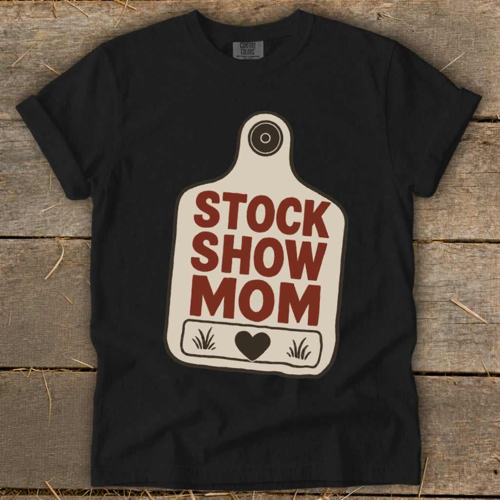 Black t-shirt with "STOCK SHOW MOM" text on a tag graphic.