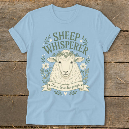 Light blue t-shirt with a sheep and text "Sheep Whisperer, it's a love language."