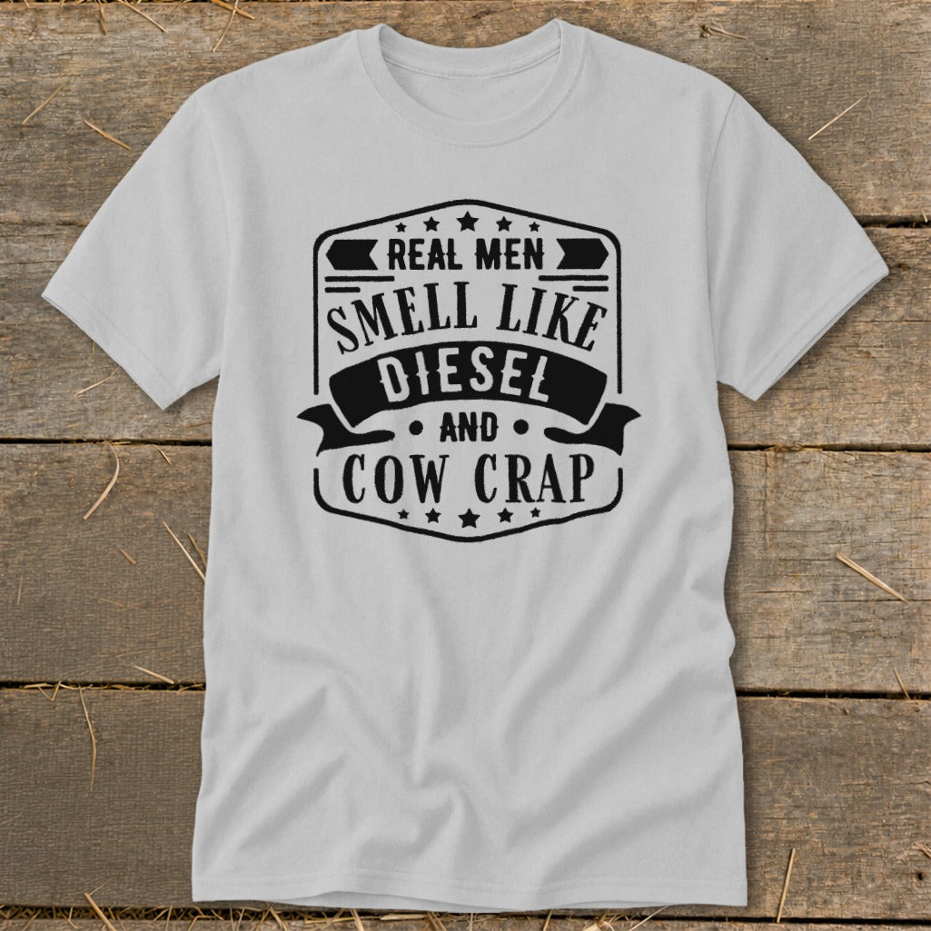 T-shirt with black text reading "Real Men Smell Like Diesel and Cow Crap".