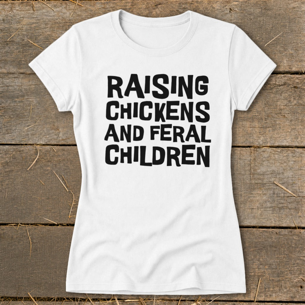 White t-shirt with black text that reads "Raising Chickens and Feral Children".