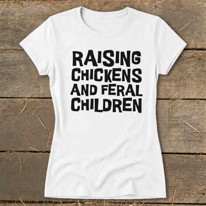 White t-shirt with black text that reads "Raising Chickens and Feral Children".