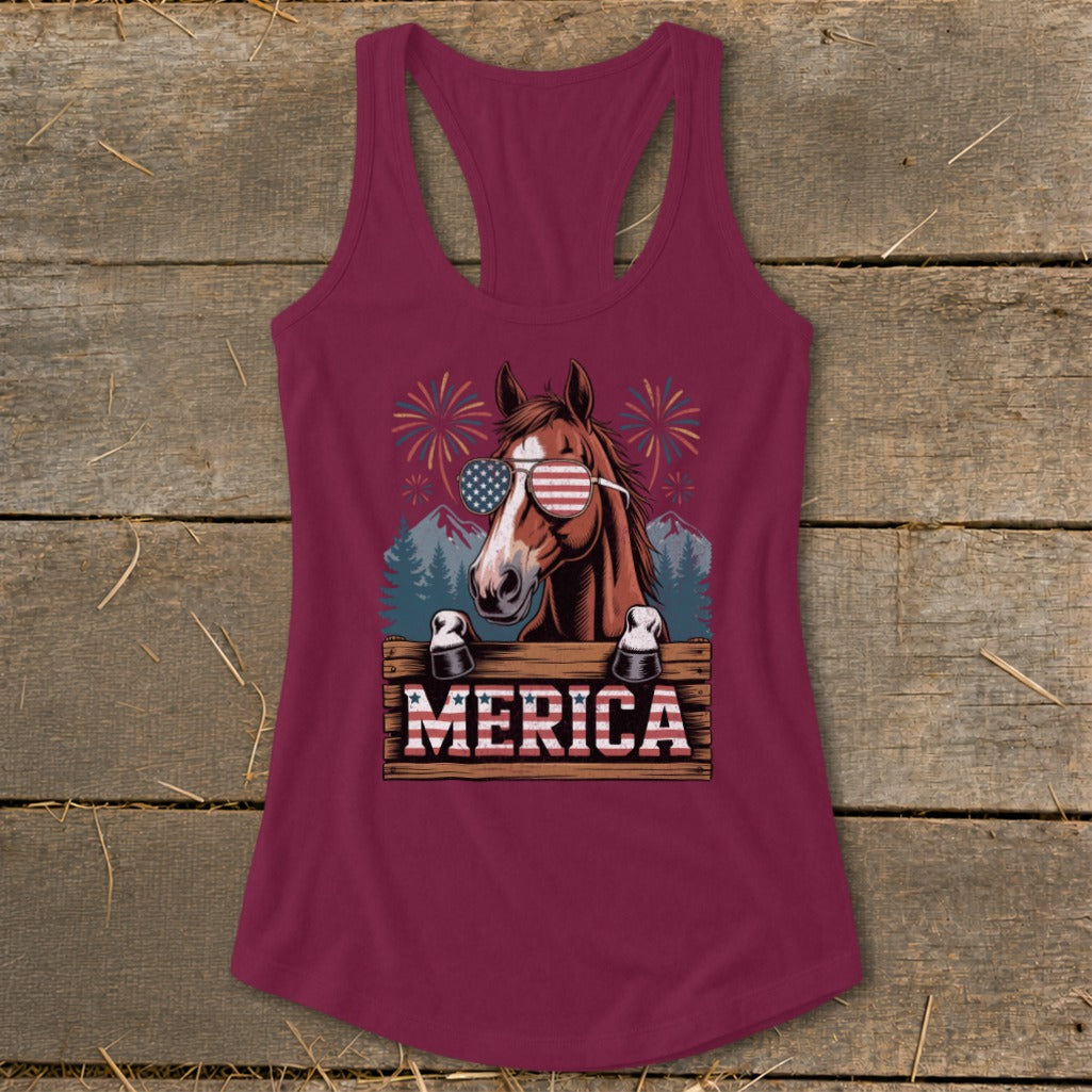 Horse with American flag sunglasses and "MERICA" text on wooden sign.