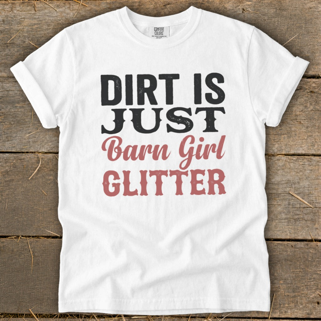 White t-shirt with black and pink text that reads "Dirt is just barn girl glitter".