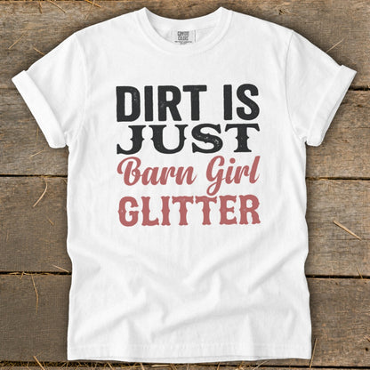 White t-shirt with black and pink text that reads "Dirt is just barn girl glitter".
