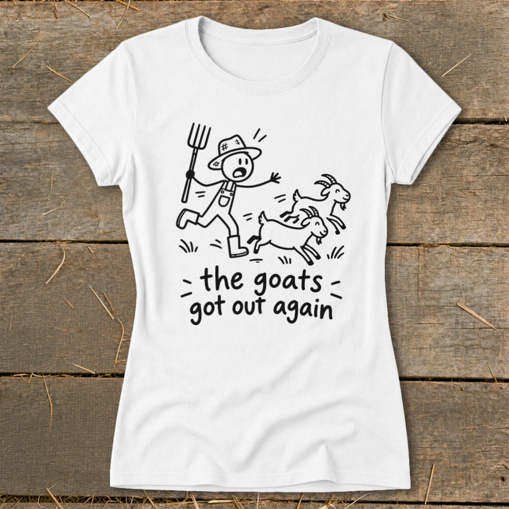 White t-shirt with black line art of a farmer chasing goats, text reads "the goats got out again".