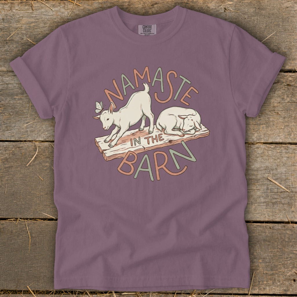 T-shirt with "Namaste In The Barn" text and cartoon goats.