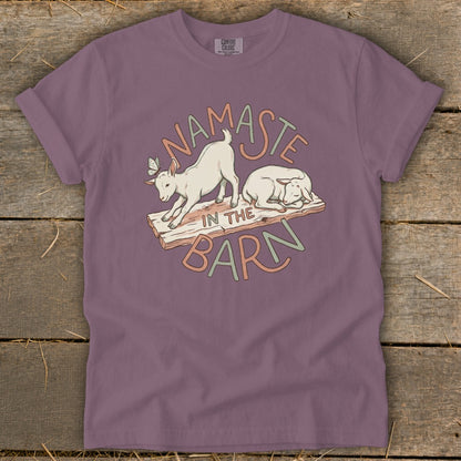 T-shirt with "Namaste In The Barn" text and cartoon goats.