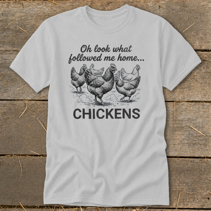Light grey t-shirt with a sketch of chickens and text reading "Oh look what followed me home... CHICKENS".