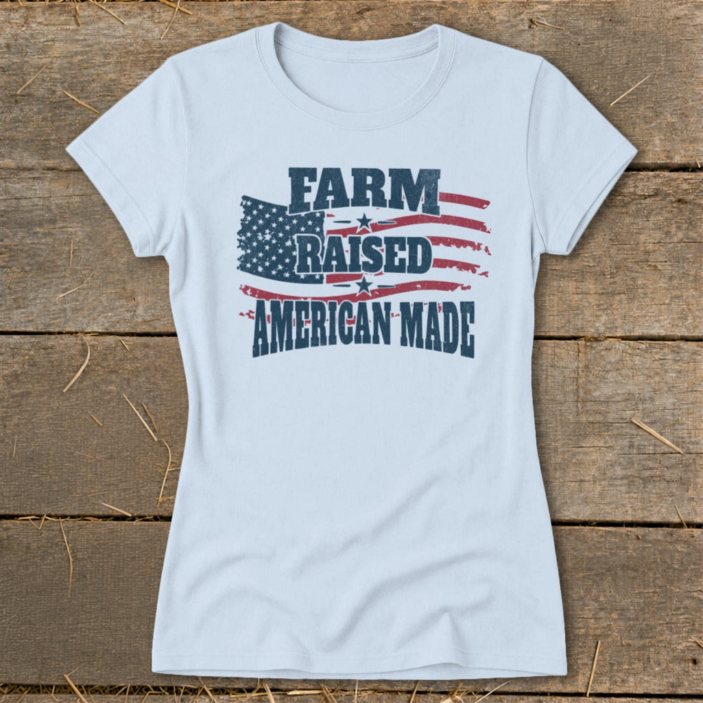 Light blue t-shirt with distressed American flag graphic and text "FARM RAISED AMERICAN MADE".