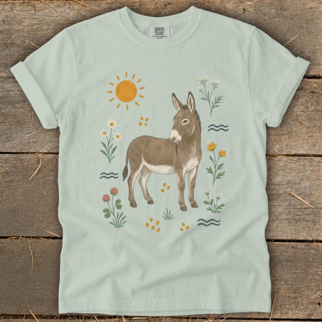 Light green t-shirt with a watercolor-style donkey and floral illustration.